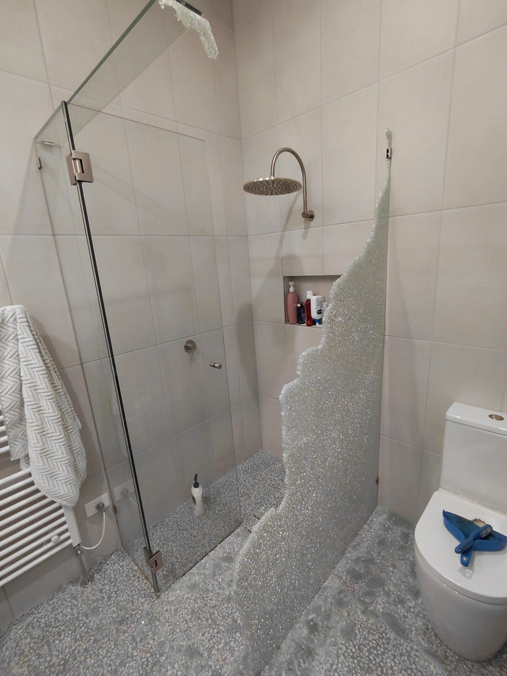 Shattered toughened side panel of a corner shower screen in Newtown with glass across the bathroom floor