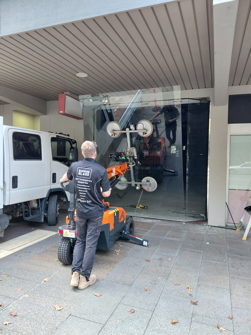 Jekko MPK06 glass lifter carrying a new display panel into the bay window at Market Square Geelong